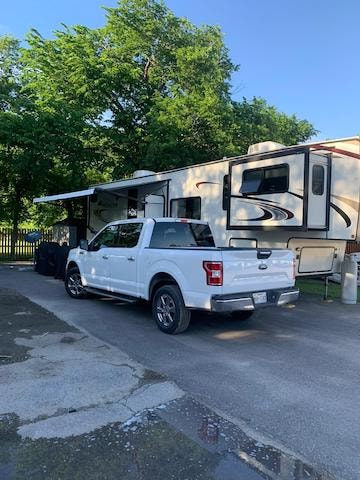 Settlers Haven RV Park - RV and truck parked at site with awning extended